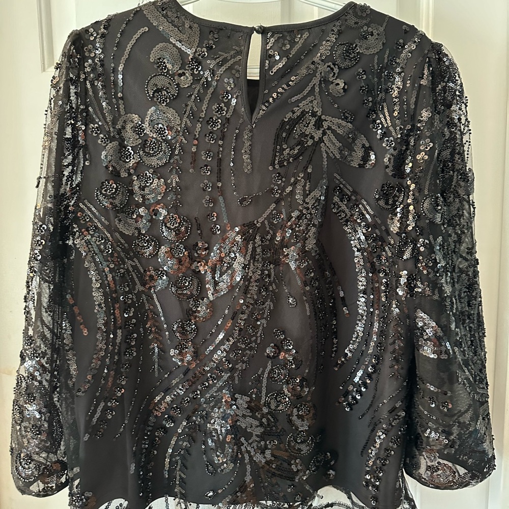 Sequin and beaded formal 3/4 length sleeved black top.